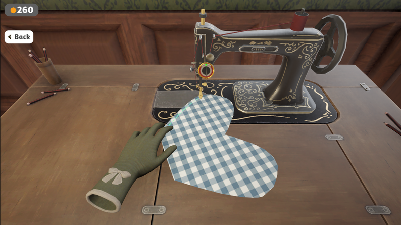 Dressmaker game blue and white checked fabric positioned under the sewing machine